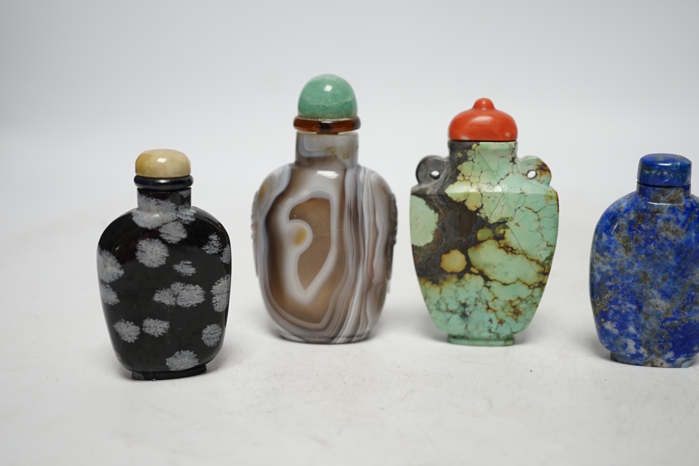 Five Chinese hardstone snuff bottles, 19th/20th century to include: black and grey marble, malachite, turquoise matrix, lapis lazuli and banded agate, largest 7.5cm high